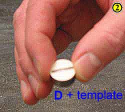 2. Place a circular paper template on top of one of the metal pellets