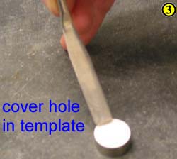 3. Add enough powder to fill the hole (make a mound) in the template