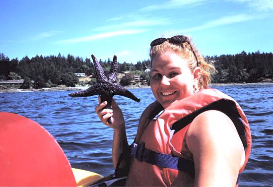 Kayaking off of Saltspring Island in B.C., holding a prime example of the purple starfish that are all over the intertidal zones on the B.C. coast.